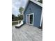 Back porch featuring new deck boards, blue siding, and outdoor furniture at 3147 Pine Needle Sw Ct, Lilburn, GA 30047