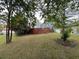 Fenced-in backyard with a mature tree and lush green lawn at 3147 Pine Needle Sw Ct, Lilburn, GA 30047