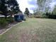 Spacious backyard with shed, lush grass, and a well-maintained garden at 3147 Pine Needle Sw Ct, Lilburn, GA 30047