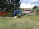 Charming backyard with a storage shed and a pergola-covered seating area at 3147 Pine Needle Sw Ct, Lilburn, GA 30047