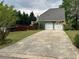 View of the backyard, featuring a driveway and an attached two car garage at 3147 Pine Needle Sw Ct, Lilburn, GA 30047