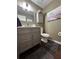 Elegant powder room with a gray vanity, marble countertop, and decorative mirror at 3147 Pine Needle Sw Ct, Lilburn, GA 30047