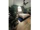 Well-lit bedroom with hardwood floors, vaulted ceiling, and a large window with privacy curtains at 3147 Pine Needle Sw Ct, Lilburn, GA 30047