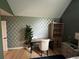 Stylish bedroom showcasing modern wallpaper accent, hardwood floors, and ample natural light at 3147 Pine Needle Sw Ct, Lilburn, GA 30047