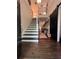 Welcoming foyer with hardwood floors and elegant staircase with stylish modern accents at 3147 Pine Needle Sw Ct, Lilburn, GA 30047