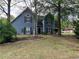 Charming blue two-story home featuring a lush landscaped yard and a welcoming front entrance at 3147 Pine Needle Sw Ct, Lilburn, GA 30047