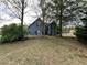 Charming blue two-story home featuring a lush landscaped yard at 3147 Pine Needle Sw Ct, Lilburn, GA 30047