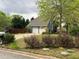 View of an attached two-car garage and well maintained landscaping at 3147 Pine Needle Sw Ct, Lilburn, GA 30047