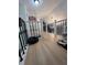 Hallway featuring beautiful hardwood floors and black metal railing at 3147 Pine Needle Sw Ct, Lilburn, GA 30047