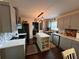 Charming kitchen with gray cabinets, an island, stainless appliances, and open floor plan at 3147 Pine Needle Sw Ct, Lilburn, GA 30047