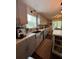 Modern kitchen with gray cabinets, a large sink, white countertops, and an island at 3147 Pine Needle Sw Ct, Lilburn, GA 30047