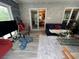 Bright living room boasts stone accent wall, modern gray floors, and access to dining room at 3147 Pine Needle Sw Ct, Lilburn, GA 30047