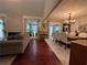 Inviting living room with stone fireplace, hardwood floors, and open dining area at 3147 Pine Needle Sw Ct, Lilburn, GA 30047