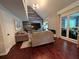 Bright living room featuring vaulted ceiling, hardwood floors, and stone accent wall at 3147 Pine Needle Sw Ct, Lilburn, GA 30047