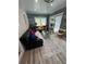 Comfortable living room featuring wood-look accent walls, gray carpet and a contemporary glass coffee table at 3147 Pine Needle Sw Ct, Lilburn, GA 30047