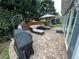 Stone patio with outdoor seating, grill, and view of backyard at 3147 Pine Needle Sw Ct, Lilburn, GA 30047