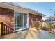 New wooden deck features brick house entrance with sliding glass doors at 8298 Holly Dr, Jonesboro, GA 30238