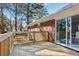 New wooden deck extends across brick exterior, sliding glass door entrance at 8298 Holly Dr, Jonesboro, GA 30238
