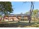 Large backyard with brick home exterior, wooden deck and new wooden fencing at 8298 Holly Dr, Jonesboro, GA 30238