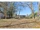 View of backyard with storage shed, new fencing and wooded surroundings at 8298 Holly Dr, Jonesboro, GA 30238