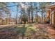 Large backyard featuring mature trees, new wooden deck and wooded surroundings at 8298 Holly Dr, Jonesboro, GA 30238