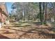 Spacious backyard with new wooden deck, partially wooded and chain link fence at 8298 Holly Dr, Jonesboro, GA 30238