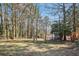 Expansive, partially wooded backyard with storage shed and chain link fencing at 8298 Holly Dr, Jonesboro, GA 30238