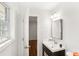 Bright bathroom features modern vanity, square mirror and wood look flooring at 8298 Holly Dr, Jonesboro, GA 30238