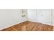 Cozy bedroom with hardwood floors, neutral paint, and a double door closet offers a calm retreat at 8298 Holly Dr, Jonesboro, GA 30238