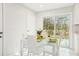 Bright dining area with glass table and seating, with sliding door to outdoor deck at 8298 Holly Dr, Jonesboro, GA 30238