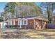 Brick home featuring white trim, a covered carport, and a fenced yard at 8298 Holly Dr, Jonesboro, GA 30238