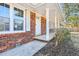 Inviting front porch with white columns and brick accents on a well-kept home at 8298 Holly Dr, Jonesboro, GA 30238