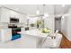 Open kitchen features a center island with seating, white cabinets and stainless appliances at 8298 Holly Dr, Jonesboro, GA 30238
