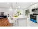 Modern kitchen featuring white cabinets, a breakfast bar, and stainless steel appliances at 8298 Holly Dr, Jonesboro, GA 30238