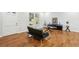 Bright living room featuring hardwood floors, ample natural light, and modern furnishings at 8298 Holly Dr, Jonesboro, GA 30238