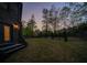 Level lot backyard with mature trees, fresh mulch, and brick veneer on rear of home at 925 Sunny Meadows Ln, Marietta, GA 30062