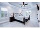 Bedroom featuring a tray ceiling, neutral carpet, and natural light at 925 Sunny Meadows Ln, Marietta, GA 30062