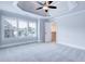 Bright bedroom with tray ceiling, carpet, and a closet through door at 925 Sunny Meadows Ln, Marietta, GA 30062