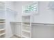 Walk-in closet featuring built-in shelving and a window at 925 Sunny Meadows Ln, Marietta, GA 30062