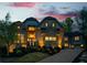 Stunning brick home with stone accents, manicured landscaping, and a welcoming driveway at twilight at 925 Sunny Meadows Ln, Marietta, GA 30062