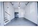 Well-lit garage featuring epoxy flooring, storage cabinets, and stairs at 925 Sunny Meadows Ln, Marietta, GA 30062