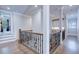 Spacious hallway featuring hardwood floors, wrought iron railings, and natural light at 925 Sunny Meadows Ln, Marietta, GA 30062