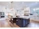 Bright, modern kitchen with stainless steel appliances, a large island, and hardwood floors at 925 Sunny Meadows Ln, Marietta, GA 30062