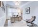 Bright home office with large windows, custom trim, and a comfortable chair for a productive workspace at 925 Sunny Meadows Ln, Marietta, GA 30062