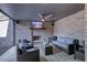 Comfortable patio with wicker furniture, ceiling fan, fireplace, and wall-mounted TV at 925 Sunny Meadows Ln, Marietta, GA 30062