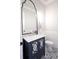 Chic powder room with decorative tile flooring, a unique vanity, and stylish mirror adding charm at 925 Sunny Meadows Ln, Marietta, GA 30062