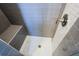 Stylish shower featuring gray tiles, a built-in bench, and a modern showerhead design at 925 Sunny Meadows Ln, Marietta, GA 30062