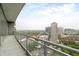 Spacious balcony overlooking the city skyline, lush greenery, and street views at 1065 Peachtree Ne St # 2803, Atlanta, GA 30309