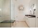 Modern bathroom featuring glass shower door, modern mirror, toilet, and granite countertop sink at 1065 Peachtree Ne St # 2803, Atlanta, GA 30309