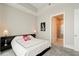 Bedroom featuring modern lamps, accent wall art, carpeted floor, and a view to the bathroom at 1065 Peachtree Ne St # 2803, Atlanta, GA 30309